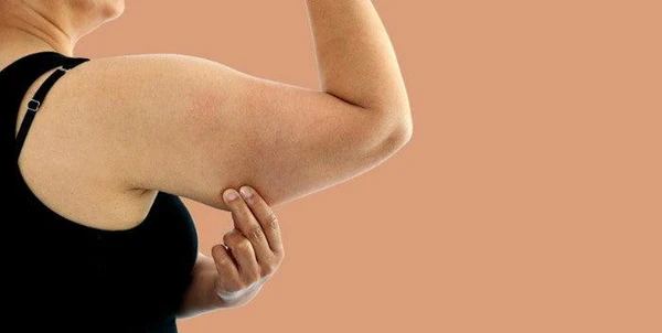 Toning Bingo Wings: Your Ultimate Guide to Sculpting Sleek Arms at the Gym 1 Woman doing push-ups for arm strength Cambridge